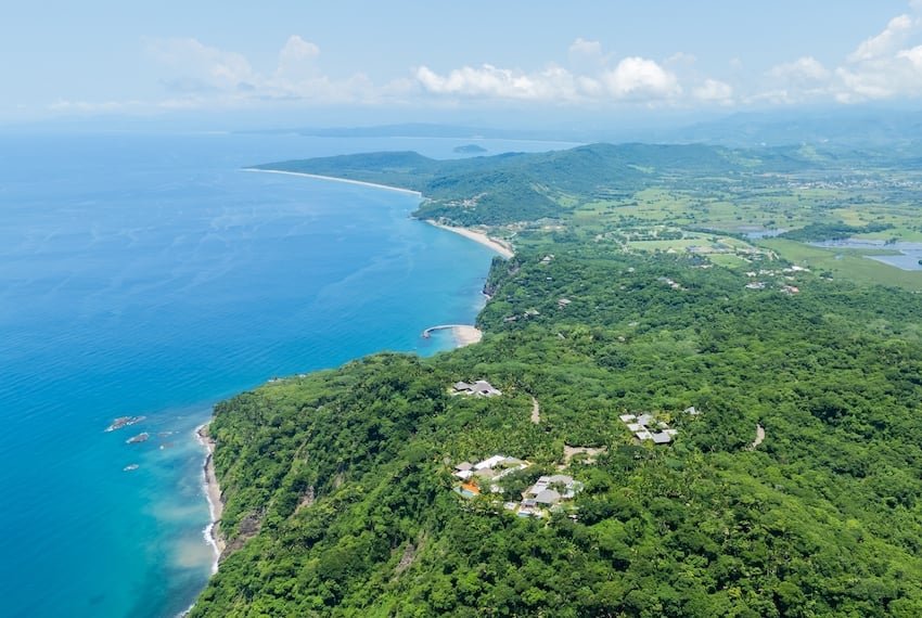 Aerial view of lo de marcos, nayarit, mexico, showcasing the stunning coastline, crystal-clear turquoise waters, sandy beach, and lush green vegetation
