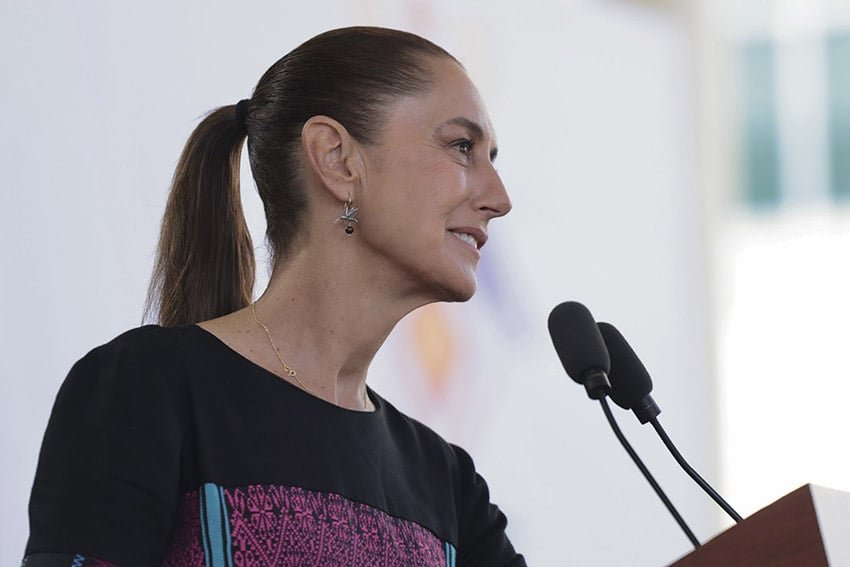 President Sheinbaum speaks into a microphone